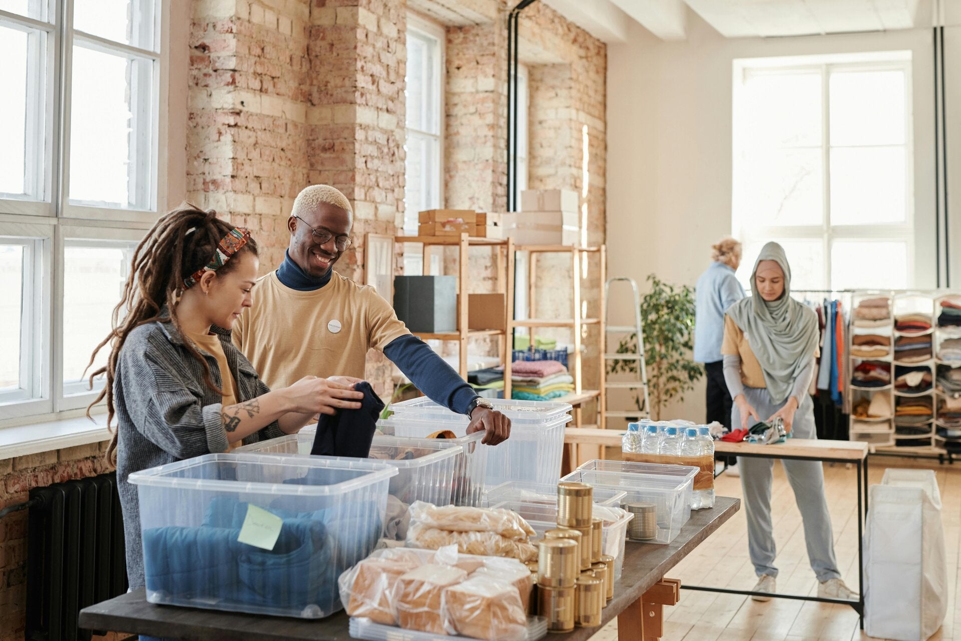 Community volunteers organizing emergency food, water, and supplies